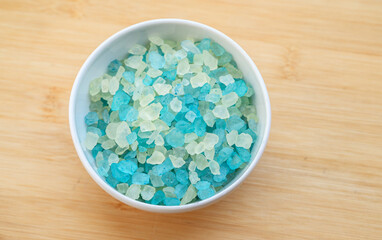 Top view of natural sea salt on wooden background.