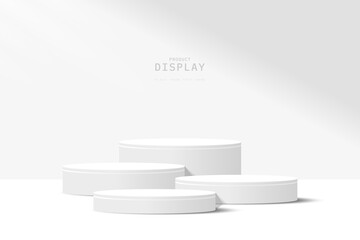 Abstract white 3D room with set of realistic gray and white cylinder pedestal podium. Minimal scene for product display presentation. Geometric forms design. Round stage for show product.