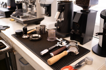 Banner of Asian Barista tamping the portafilter and preparing cup of coffee