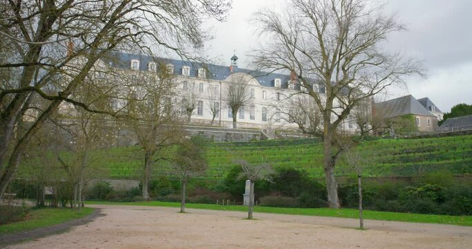 Architecture Of Abbaye Saint-Nicolas With Bare Trees During Winter In Angers, France. Low Wide Angle