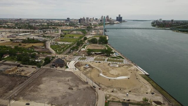 Riverside park under construction with Ambassador bridge and Detroit skyline, aerial view