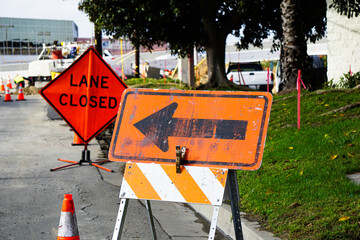 Road work with arrow and lane closed sign