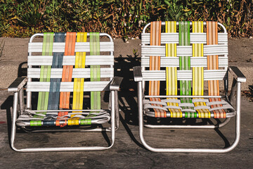 Colorful retro lawn chairs on street