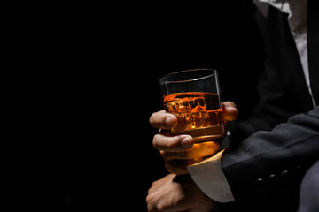 Closeup businessmen holding a glass of whiskey