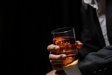 Closeup businessmen holding a glass of whiskey