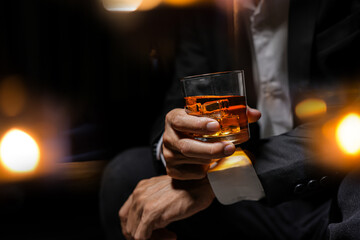 Closeup businessmen holding a glass of whiskey