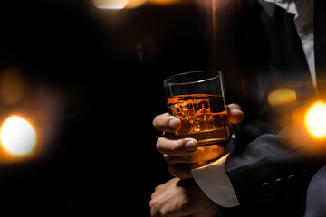Closeup businessmen holding a glass of whiskey