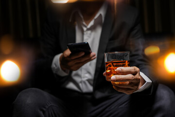 Closeup businessmen holding a glass of whiskey