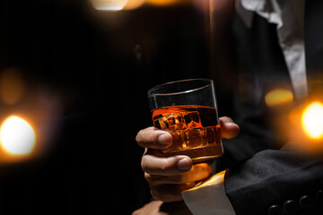 Closeup businessmen holding a glass of whiskey