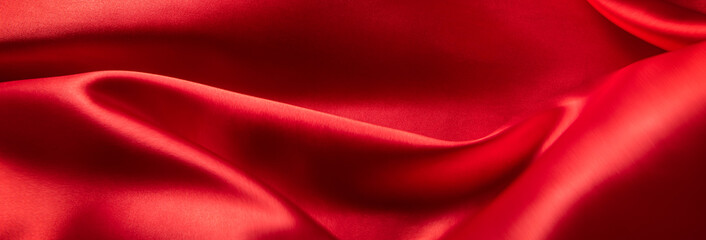 Fototapeta na wymiar ドレープのある赤い布地の背景テクスチャー