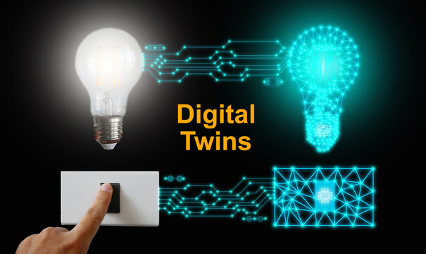 Digital Twins Concept. A Light Bulb And Its Mirrored Body Are Controlled Or Switched On By One Single Push On Either Side Of The Physical Or Digital World. Business And Technology Simulation Modeling