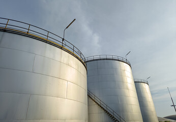 Oil storage tank In industrial areas. Crude oil storage plant For export. Palm oil factories in Asia. The atmosphere at sunset. With in the industrial plant. Zone tank storage industry. Power station 