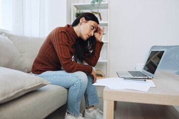 Fototapeta premium Woman working from home freelance in laptop online, overwork and fall depression