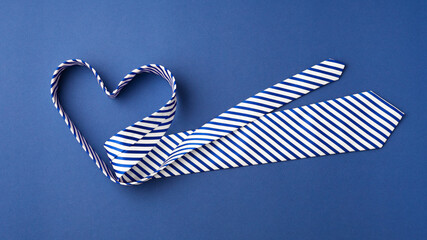 Tie in heart shape on blue background