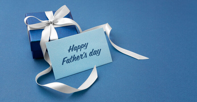 Happy fathers day card with gift box on blue background