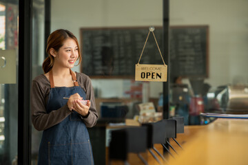 A young coffee shop employee is opening a shop for service.