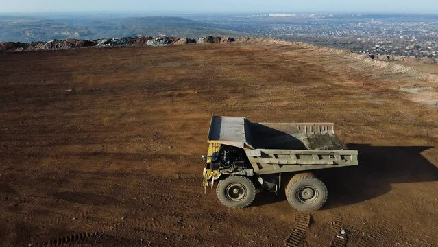 big mining truck in the quarry rides with iron ore overflight drone