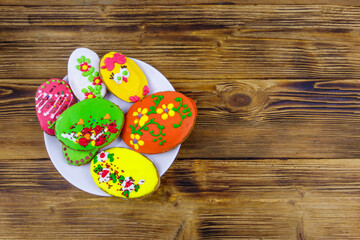 Obraz na płótnie Canvas Egg shaped easter gingerbread cookies on wooden table. Top view. Sweets for celebrate Easter