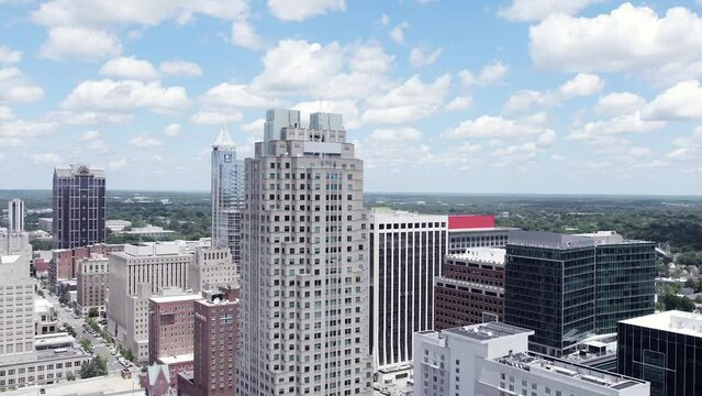 Aerial establishing shot of Raleigh, NC skyline on beautiful summer day.