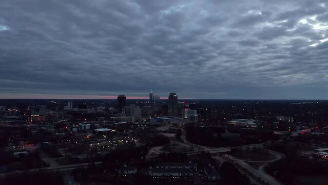 Aerial shot of Raleigh, NC during cloudy sunset. Establishing shot from drone.