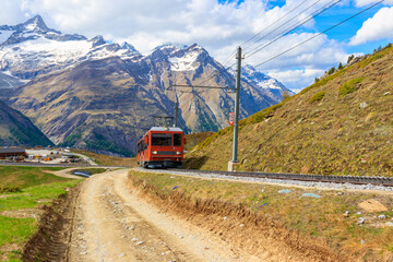Fototapeta na wymiar Beautiful view of the Swiss Alps with cogwheel train of Gornergrat railway close to Zermatt, Switzerland