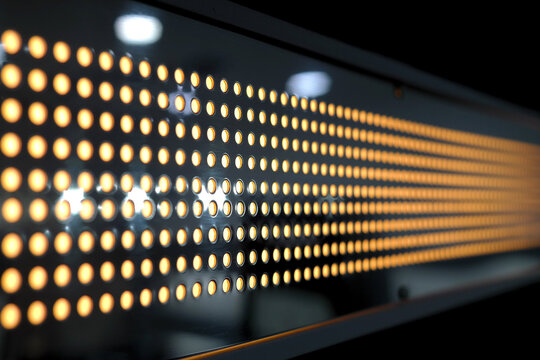 There is a hole in the metal wall and a light is in it. - Powered by Adobe