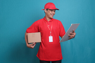 Deliveryman with box and clipboard isolated on blue background