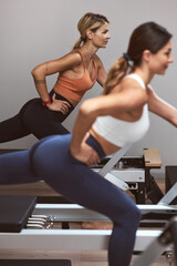 Fototapeta na wymiar Young women exercising in a gym.