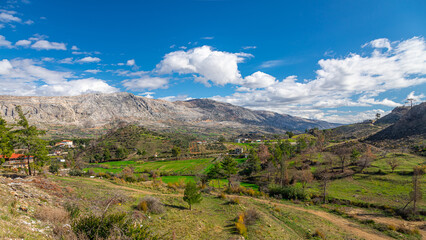 Naklejka premium Panoramic view of a mountain river and a small village, valley. Mountain river stream landscape