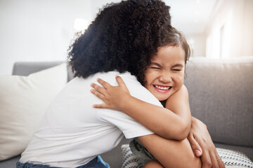 Love, hug and girl with mother on a sofa, happy and smile while hugging in their home together. Family, embrace and parent with child on a couch, bond and cheerful, loving and caring in a living room