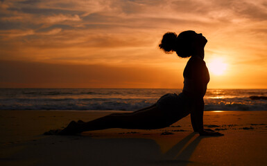 Sunset yoga, fitness and silhouette of a woman at the beach for mindfulness training at night....