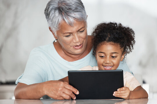 Grandmother, learning and girl with tablet in home for streaming video, movie or social media. Bonding, touchscreen and care of happy grandma with child watching film or web browsing on technology.