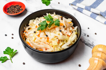 sour cabbage in wooden bowl pepper on white table Fermented vegetable concept Healthy food Top view