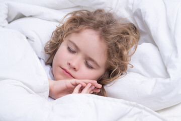 Morning sleeping. Kid sleeping in bed. Child sleeping in bed under blanket. Kid lying on pillow, child rest asleep, enjoy healthy sleep or nap.