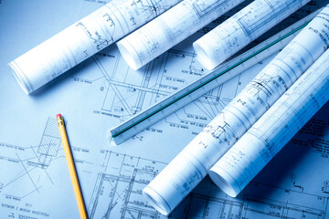 Architect and contractor concept. Rolls with projects. Plans and notebook on the desk.