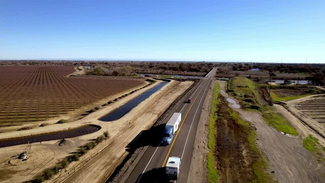 trucks on highway near san joaquin river near modesto california