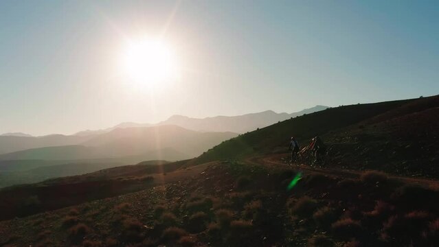gravelbikes riding up a mountain at sunrise