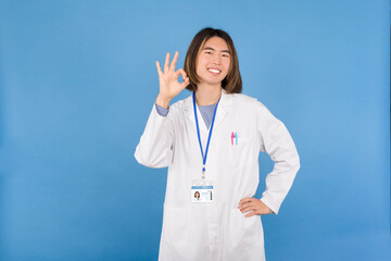 An asian doctor gesturing approval with hand