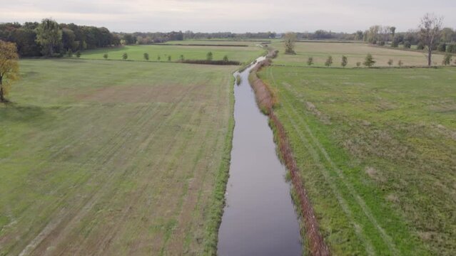 Areal footage of place called Uetz in Brandenburg, Germany. Autumn colors and atmosphere, view of water channel running through fields.