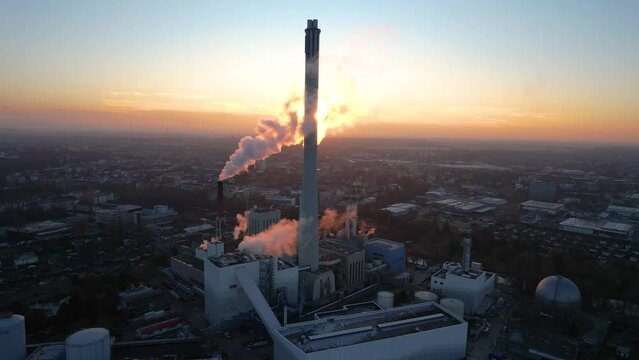 Rotating shot of the sunsetting behind the powerplant letting off steam in Brunswick 