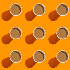 Seamless pattern with coffee cup on orange background.