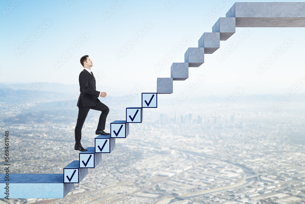 Canvas Prints side view of young business man getting work down while walking up on concrete stairs with ticks on 