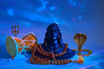 Shivaratri background with Shivas trident, Pellet Drum Damroo musical instrument ans snake . Maha...