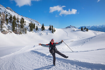 middle-aged woman has fun winter hiking in rofan
