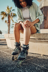 Knee pain, roller skater injury and woman in city after accident or fall outdoors. Sports, training...
