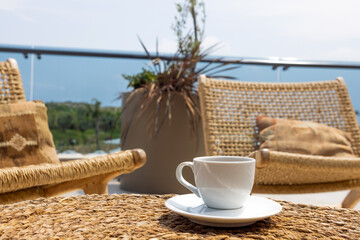 Fototapeta na wymiar Morning cup of coffee in resort spa hotel sea on light background. Morning sunlight. Tropical beach.
