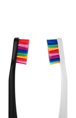 Black and White toothbrushs with multicolored bristles on white background. Bristles in all colors of the rainbow. Rainbow toothbrush Fashionable oral care