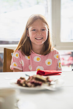 Smiling girl with pastry cake