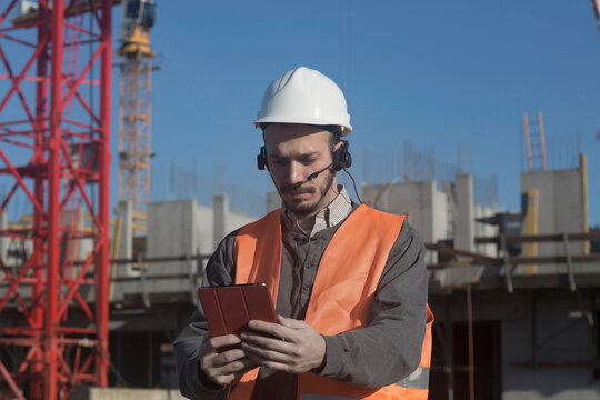 Young male engineer using digital tablet at construction site, Freiburg Im Breisgau, Baden-W&uuml;rttemberg, Germany