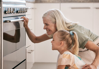 Baking, kitchen and grandmother with a child by the oven watching the cake, cookies or pie bake....